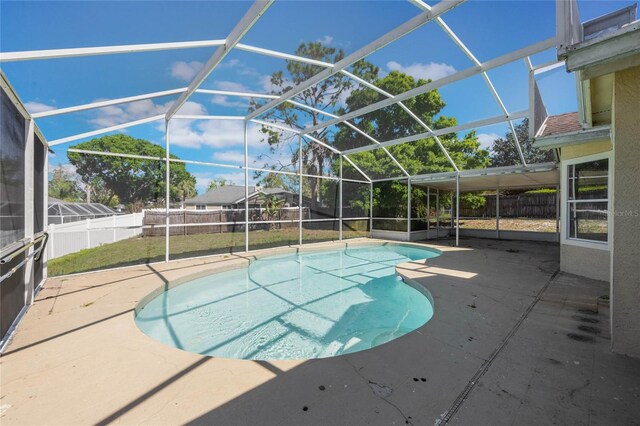 view of pool featuring glass enclosure, a patio, a fenced in pool, and a fenced backyard