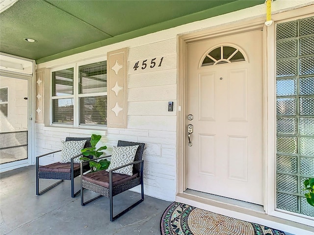 doorway to property featuring covered porch