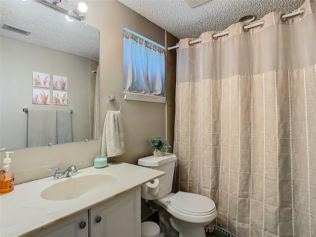 bathroom featuring curtained shower, visible vents, toilet, a textured ceiling, and vanity