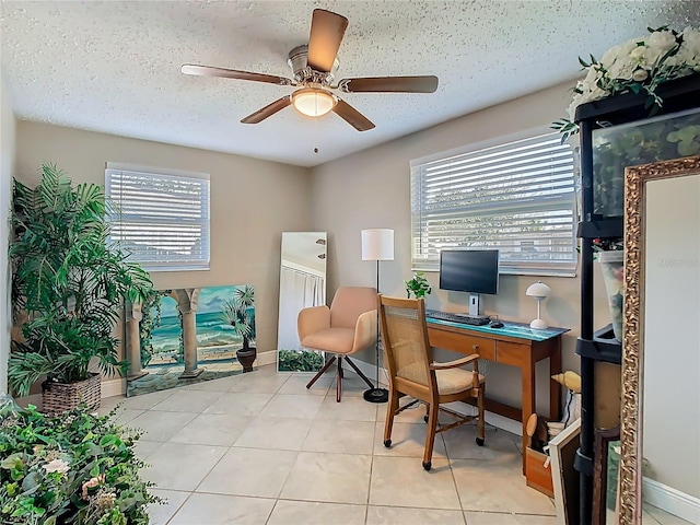 tiled office space featuring ceiling fan and a textured ceiling