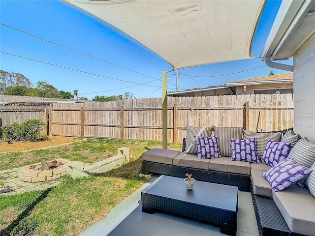 view of patio with an outdoor living space with a fire pit and fence