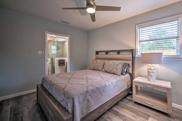 bedroom with visible vents, baseboards, and wood finished floors