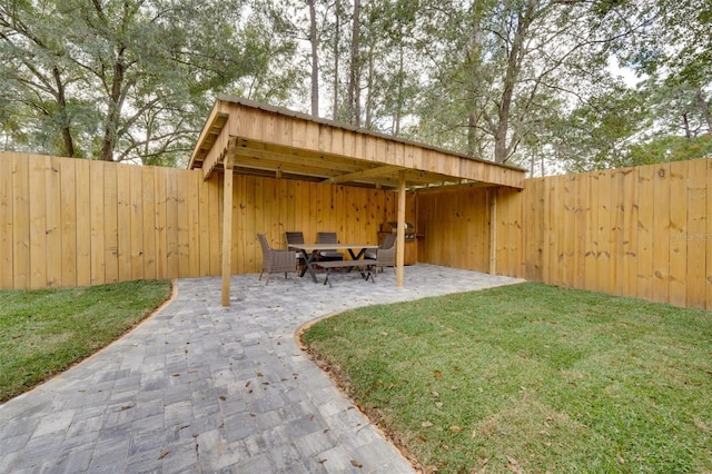 view of yard featuring fence and a patio