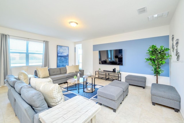 living room with light tile patterned floors and visible vents