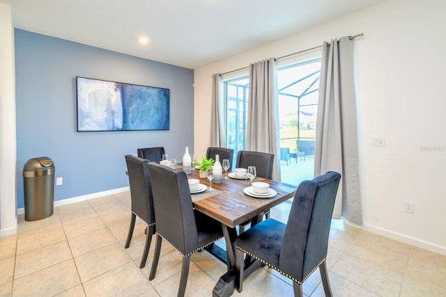 dining room featuring light tile patterned floors and baseboards