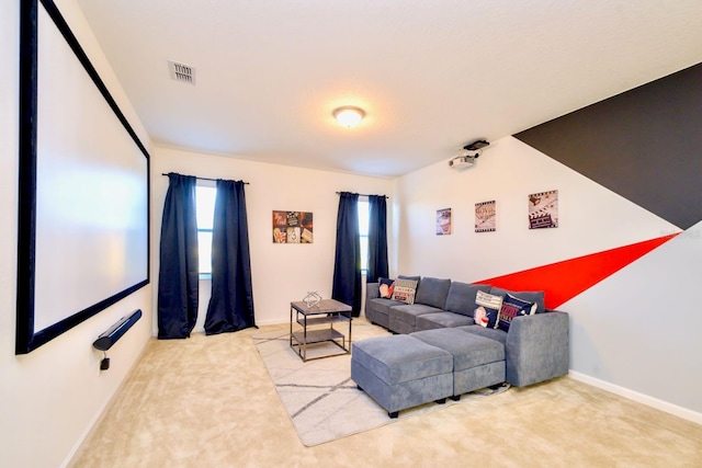 carpeted living area with visible vents and baseboards