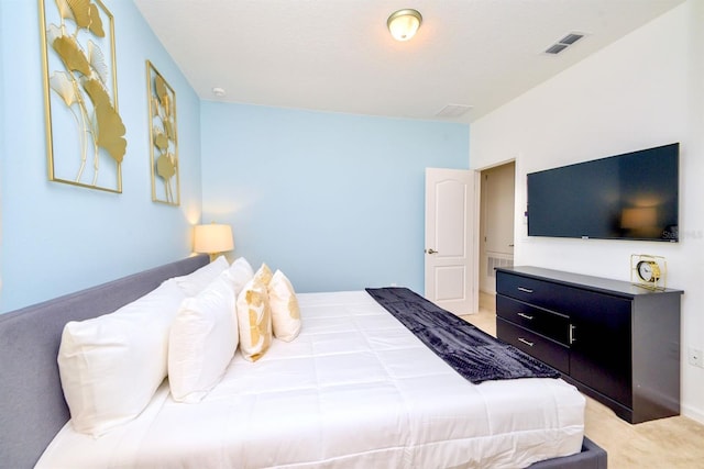 bedroom with visible vents and light colored carpet