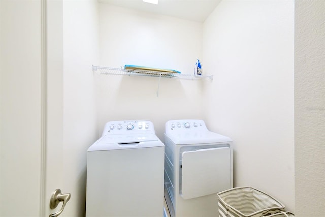 clothes washing area featuring laundry area and separate washer and dryer