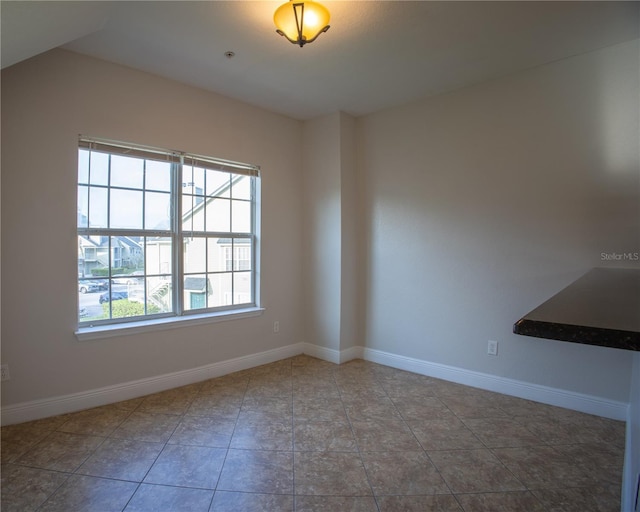 tiled spare room with baseboards