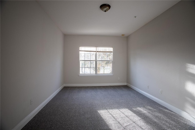 empty room with carpet floors and baseboards