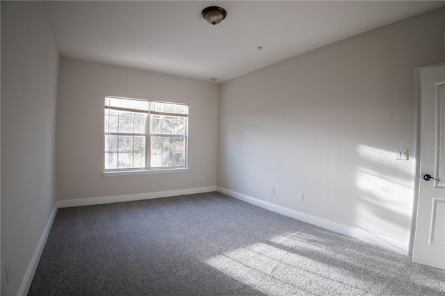 spare room with carpet and baseboards