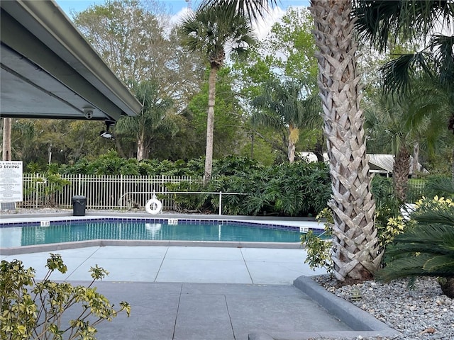 pool featuring a patio area and fence