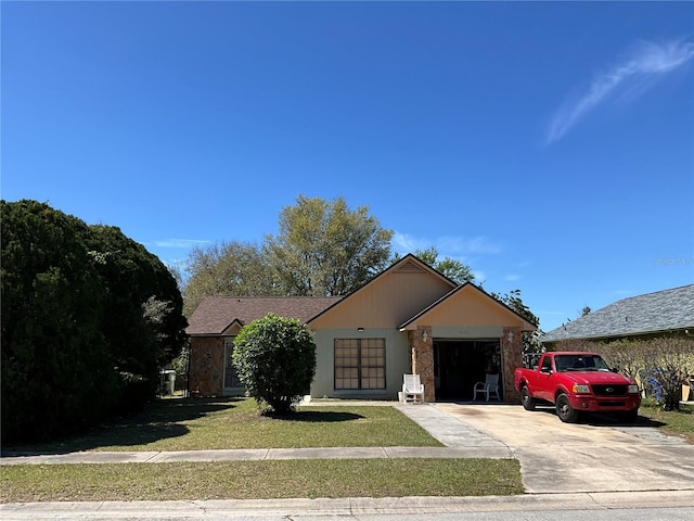 view of front of home featuring a garage, concrete driveway, and a front yard