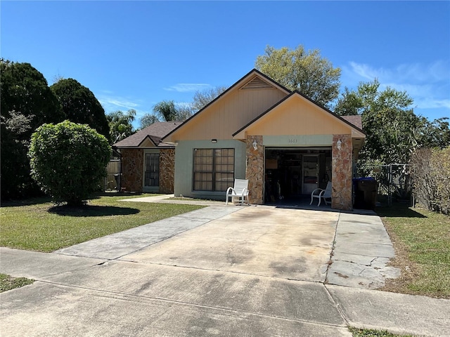 view of front of property with an attached garage, driveway, and a front lawn