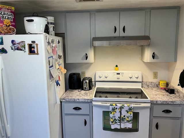 kitchen with gray cabinets, white appliances, light countertops, and under cabinet range hood