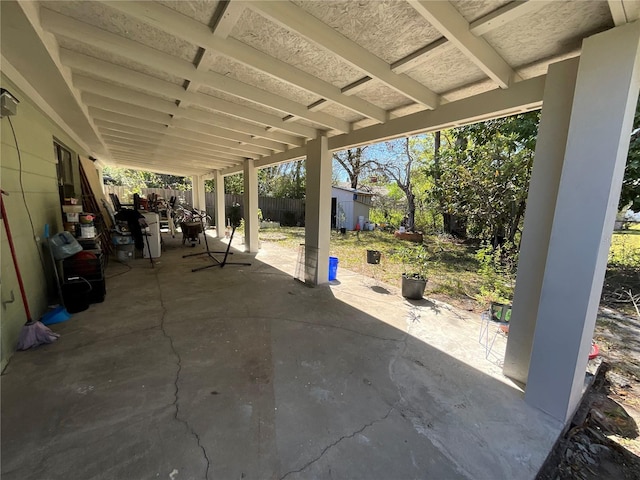 view of patio featuring an outbuilding, a storage shed, and a fenced backyard