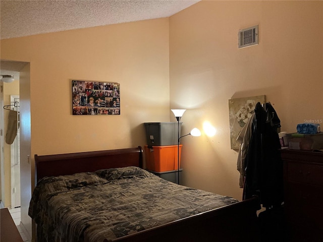 bedroom featuring a textured ceiling and visible vents