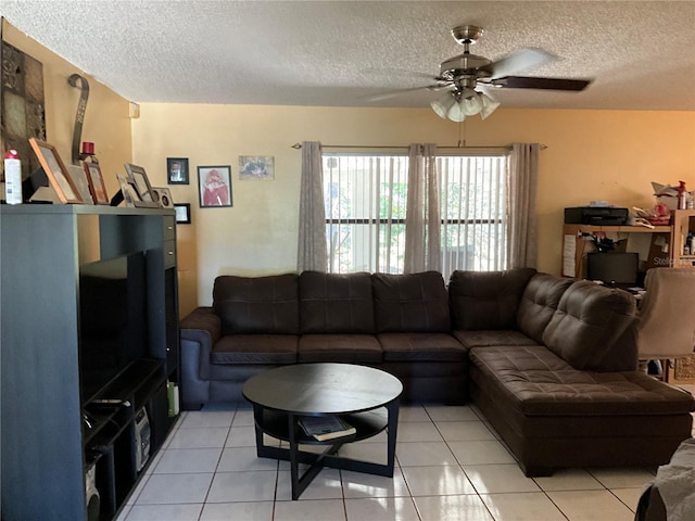 living area featuring ceiling fan, a textured ceiling, and light tile patterned floors