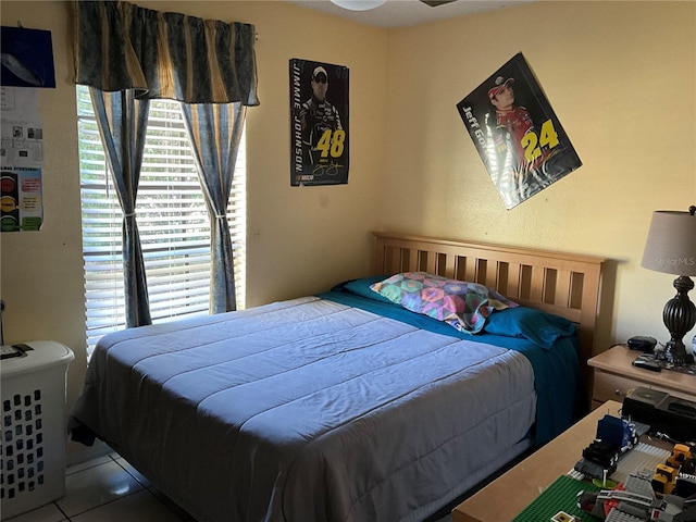 tiled bedroom featuring multiple windows