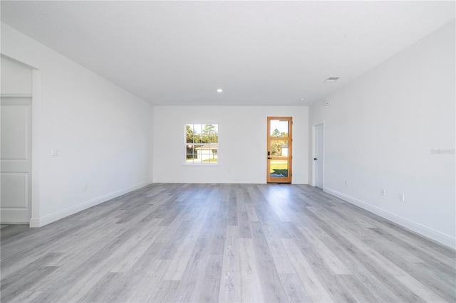 spare room with light wood-style floors and baseboards