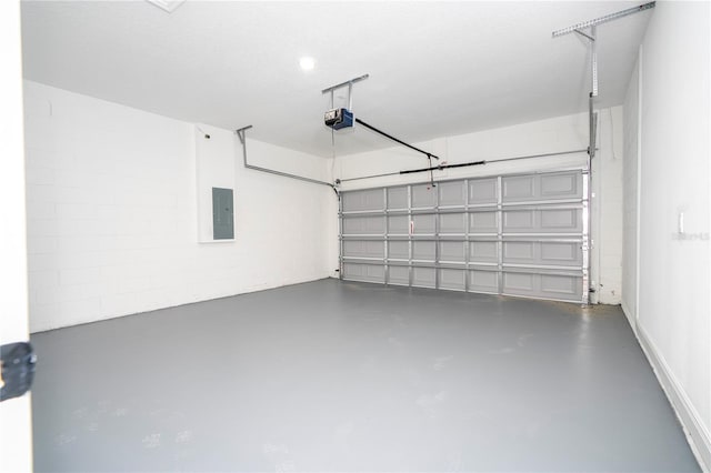 garage with a garage door opener and electric panel