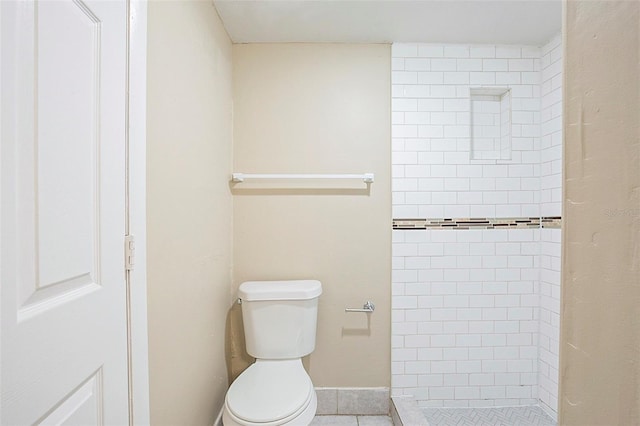 bathroom featuring toilet and a shower stall