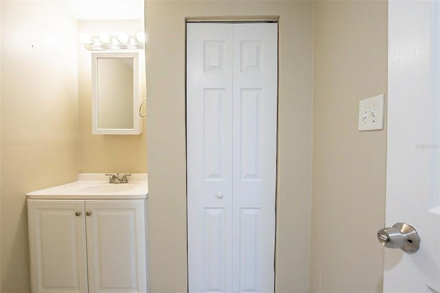 bathroom featuring vanity and a closet