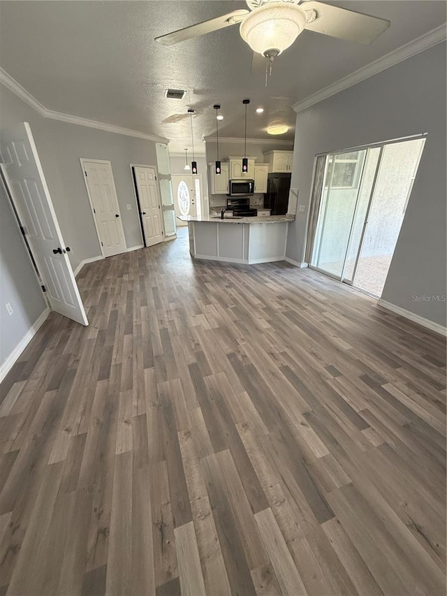 3206 Valerie Blvd, Sebring, FL 33870 - unfurnished living room featuring ceiling fan, a textured ceiling, dark wood finished floors, and crown molding