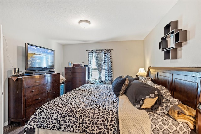 bedroom featuring a textured ceiling and wood finished floors