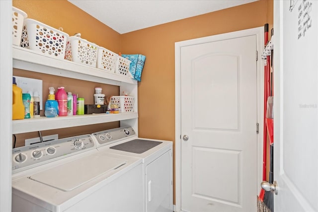 clothes washing area featuring laundry area and washer and clothes dryer