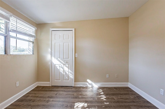 empty room with wood finished floors and baseboards