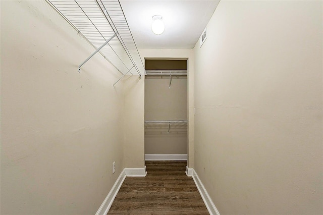 walk in closet with visible vents and wood finished floors