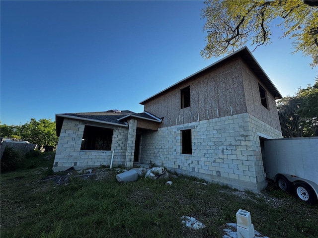 view of front of property featuring stone siding and a front lawn