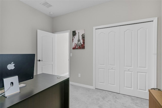 home office featuring baseboards, visible vents, and light colored carpet