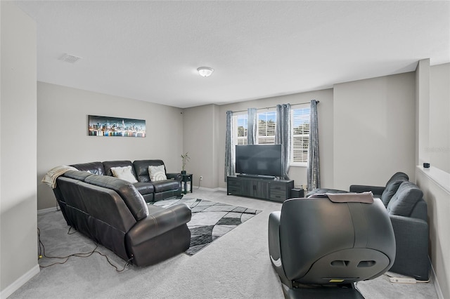 living room featuring baseboards, visible vents, and light colored carpet