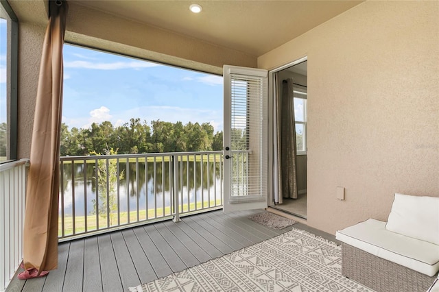 unfurnished sunroom featuring a water view