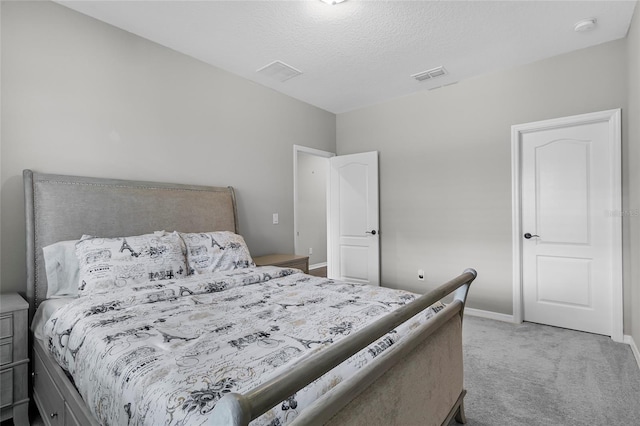 carpeted bedroom with baseboards, visible vents, and a textured ceiling