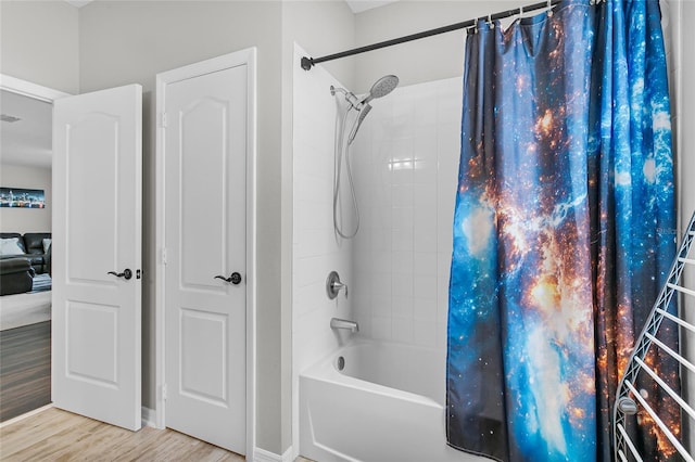 bathroom with shower / tub combo, visible vents, and wood finished floors