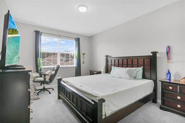 bedroom featuring baseboards and light colored carpet