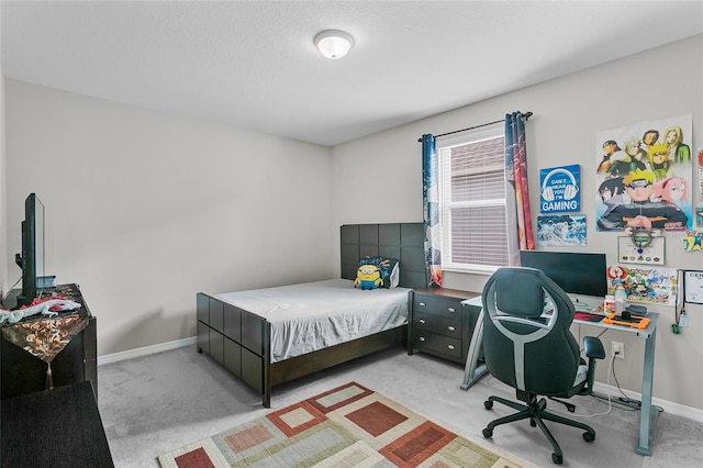 bedroom with light carpet and baseboards