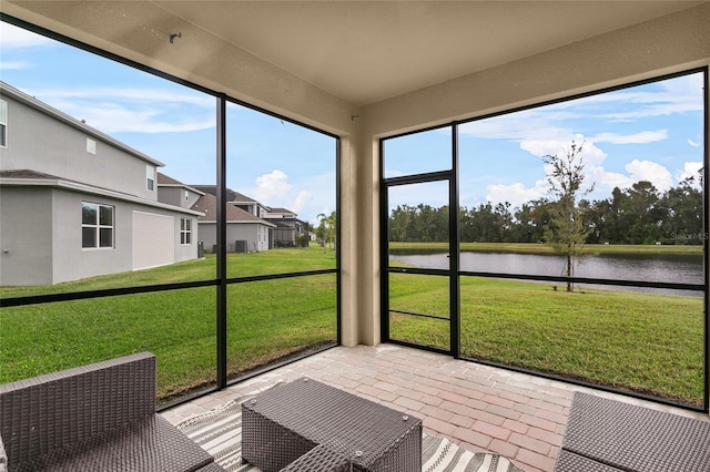 unfurnished sunroom featuring a water view