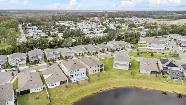 drone / aerial view featuring a residential view and a water view