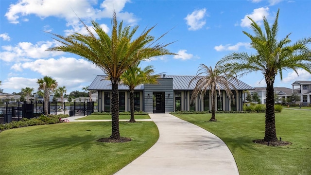 view of home's community featuring a yard and fence