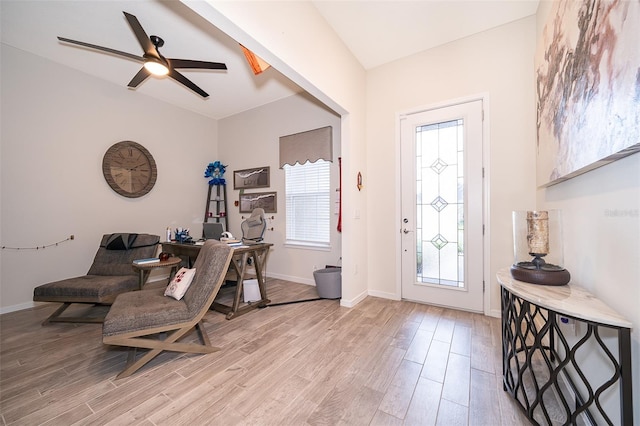 entryway with light wood-style floors, ceiling fan, and baseboards