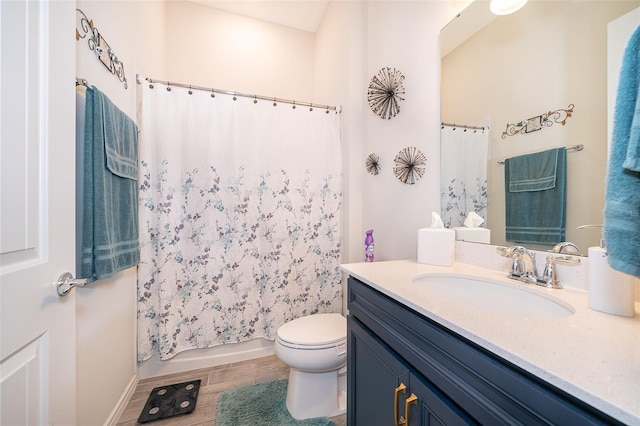 bathroom with wood finished floors, vanity, toilet, and shower / bathtub combination with curtain