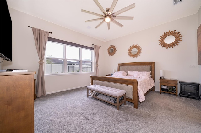 carpeted bedroom featuring baseboards, visible vents, and a ceiling fan