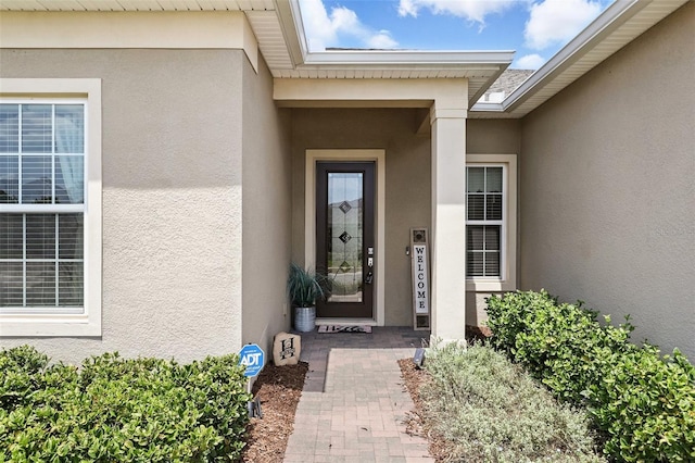 entrance to property with stucco siding