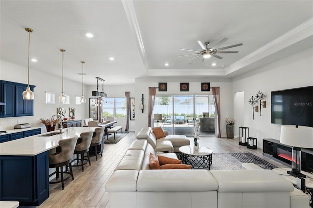 living area with recessed lighting, light wood-style floors, and a ceiling fan