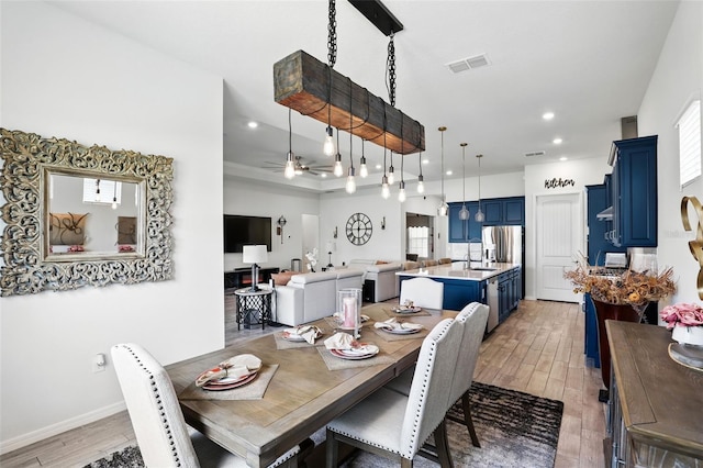 dining room featuring light wood-style flooring, baseboards, visible vents, recessed lighting, and a ceiling fan