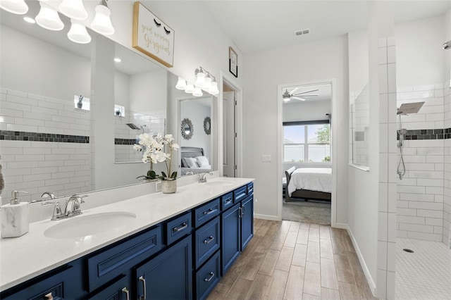 ensuite bathroom featuring ceiling fan, a sink, and connected bathroom